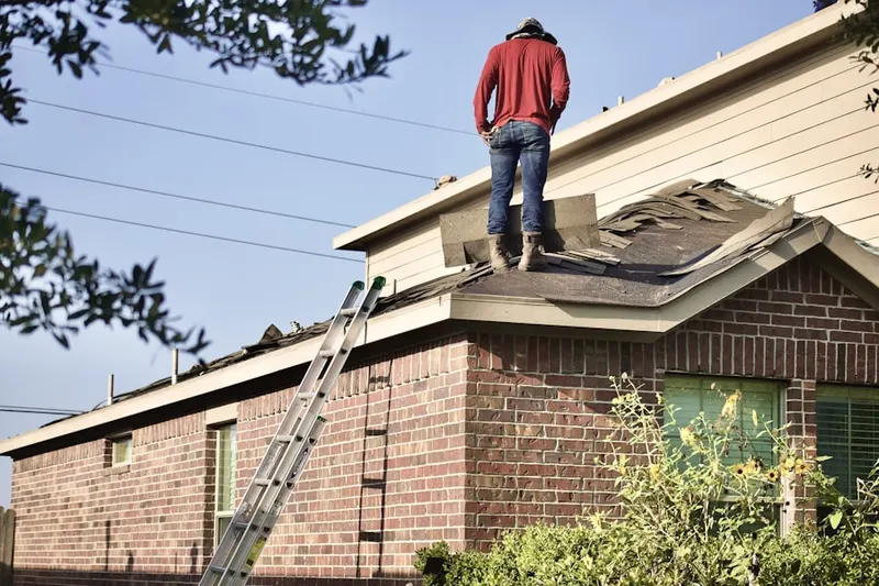 Professional roofer working on a residential roof in Lyonsville